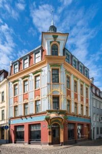 Art Nouveau sun motif and chestnut leaves on Kalēju 23 facade Riga