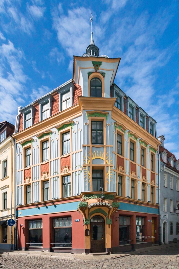 Art Nouveau sun motif and chestnut leaves on Kalēju 23 facade Riga