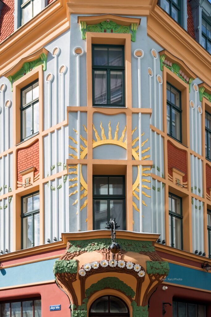Art Nouveau sun motif and chestnut leaves on Kalēju 23 facade Riga