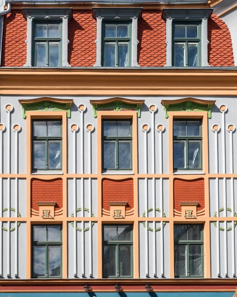 Art Nouveau sun motif and chestnut leaves on Kalēju 23 facade Riga
