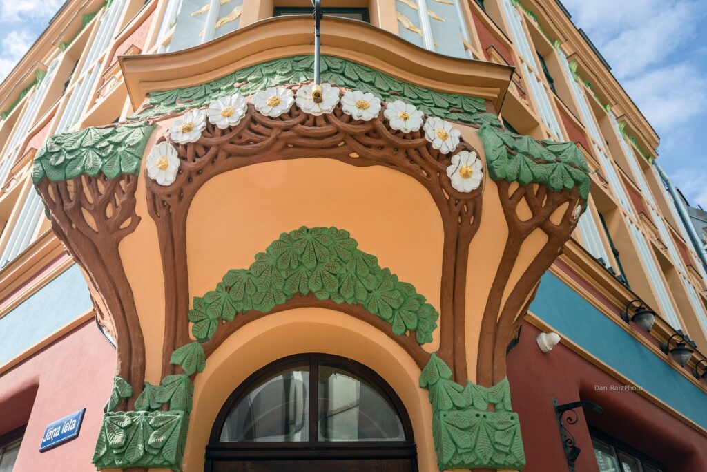 Art Nouveau sun motif and chestnut leaves on Kalēju 23 facade Riga