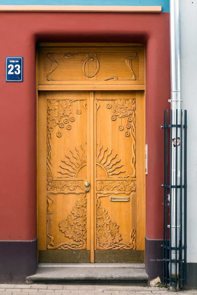 Art Nouveau sun motif and chestnut leaves on Kalēju 23 facade Riga