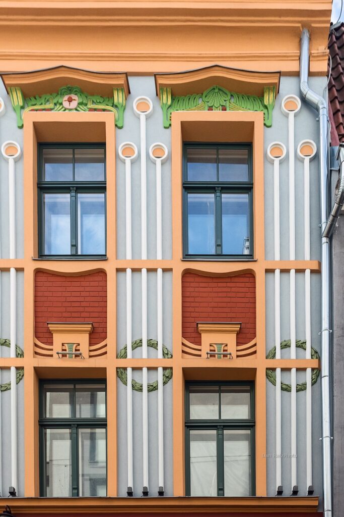 Art Nouveau sun motif and chestnut leaves on Kalēju 23 facade Riga